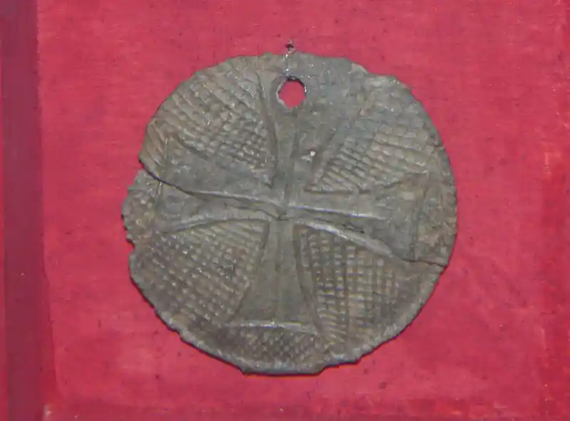 A cross inside a circle pendant